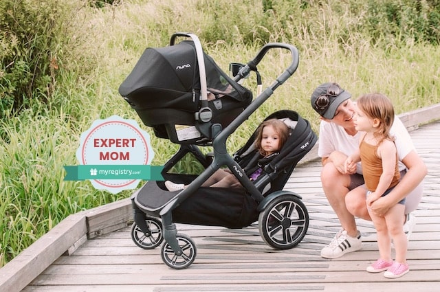 How to Choose the Best Stroller and Car Seat for You, Savannah Walsh standing on a boardwalk in a field, kneeling down next to her daughter, behind a double stroller with her two youngest kids.